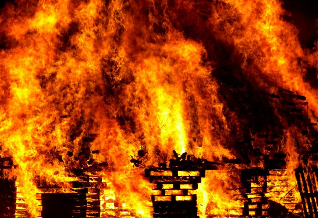 Intense flames engulf wooden pallets in a breathtaking display of fire and heat.